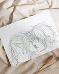 Hand-drawn sketch of two elf characters intimately touching foreheads on white paper over beige fabric