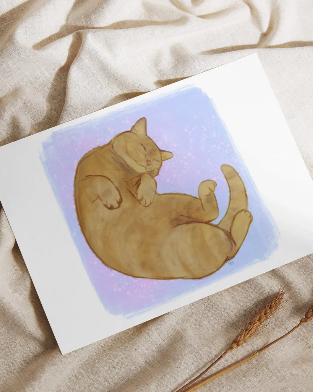 Illustration of a sleeping brown tabby cat on a purple and pink speckled background print on fabric