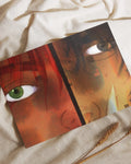 Close-up digital art of two faces with green and blue eyes, warm red and orange tones on fabric background